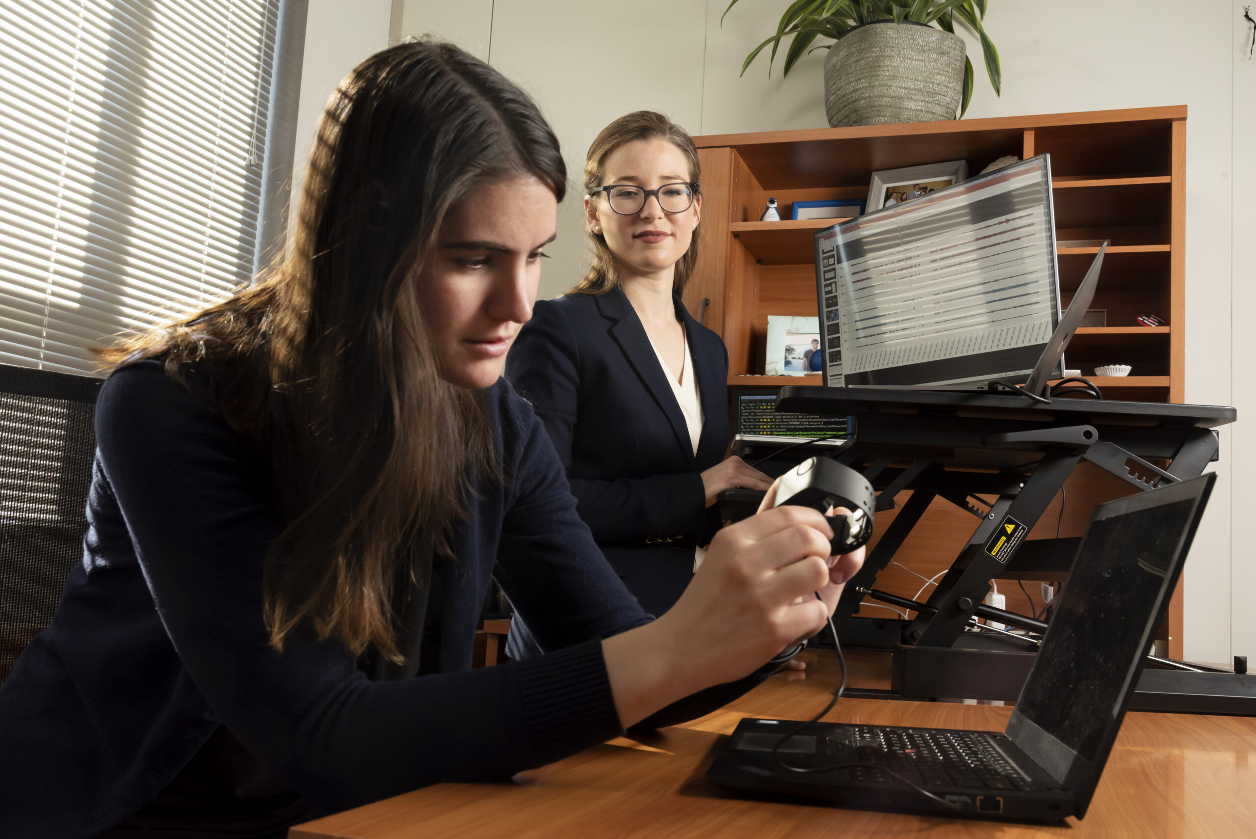 Jessilyn Dunn with PhD student Brinnae Bent who is preparing to download information from a wearable health monitoring device